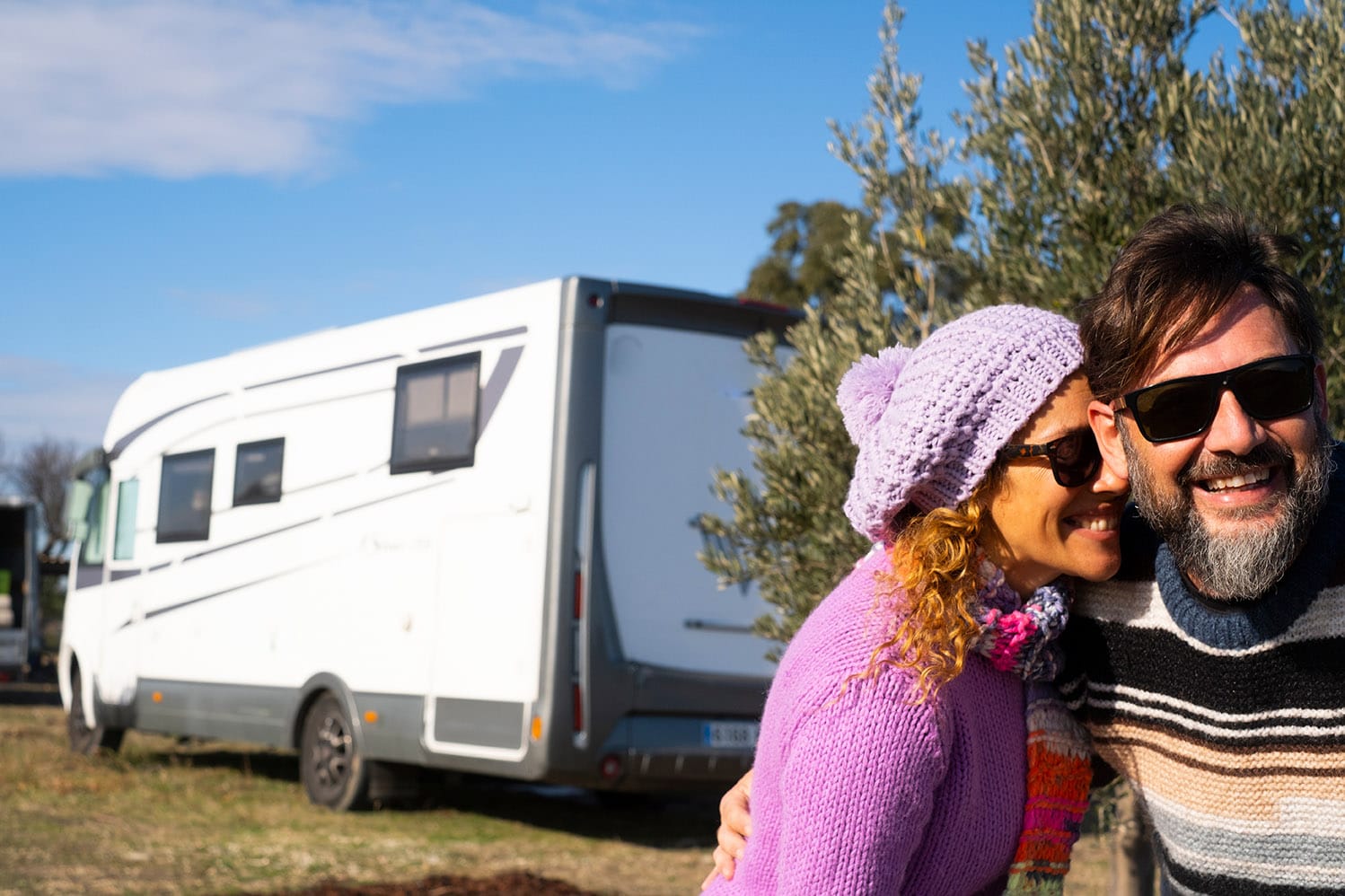 Couple next to their RV storage and boat parking